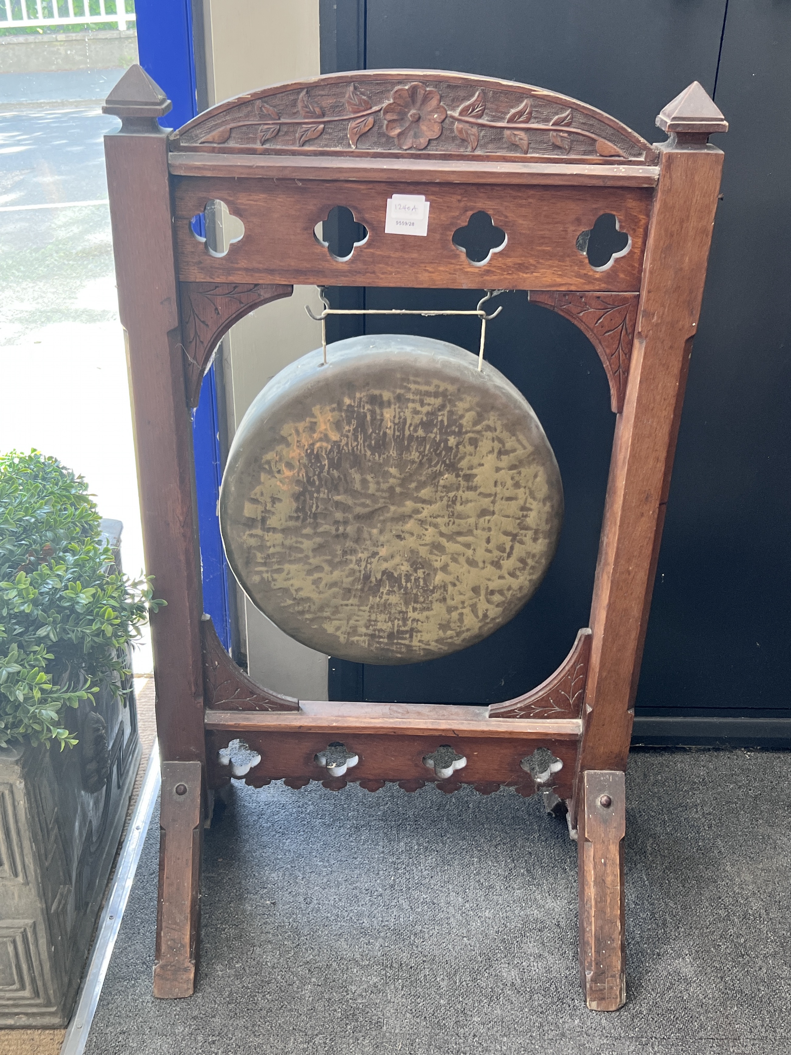 A Victorian Gothic revival oak dinner gong, width 57cm, height 100cm